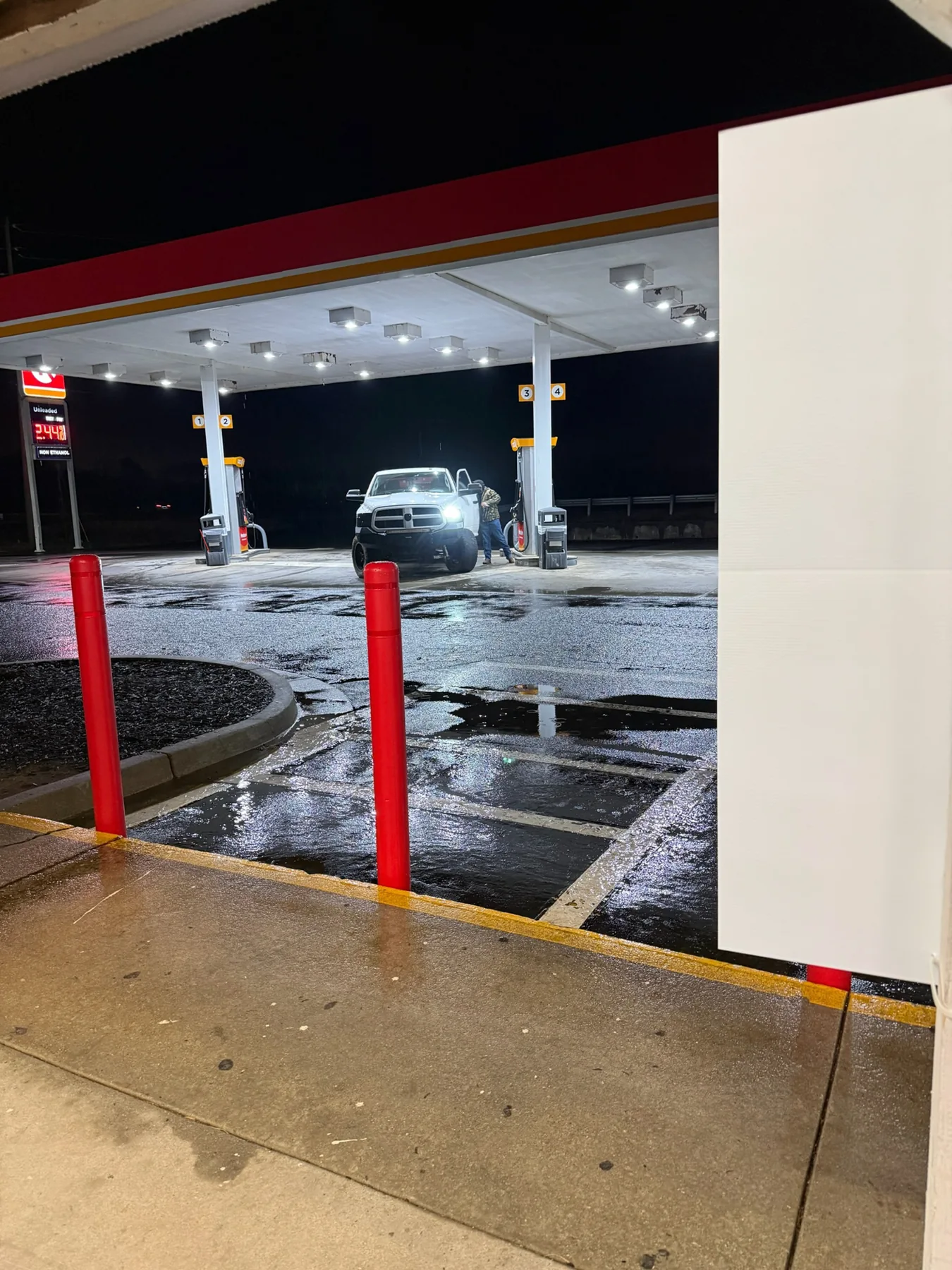 Exterior canopy lights illuminating a commercial property at night.